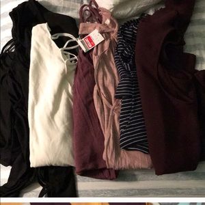 Total of twelve sweaters and shirts.